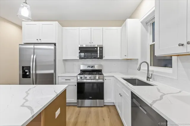 a kitchen with a sink a stove and refrigerator