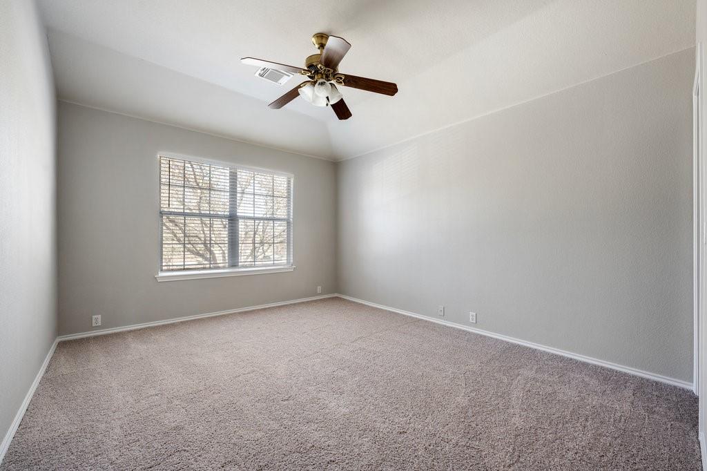 1216 Mathias Street Cedar Park, TX 78613 - Photo 11 of 16 Spare room with light colored carpet, ceiling fan, and lofted ceiling