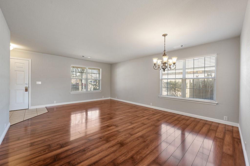 1216 Mathias Street Cedar Park, TX 78613 - Photo 2 of 16 Spare room featuring a chandelier and hardwood / wood-style flooring
