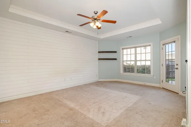a living room with furniture and a ceiling fan