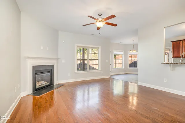 a living room with furniture a fireplace and a large window