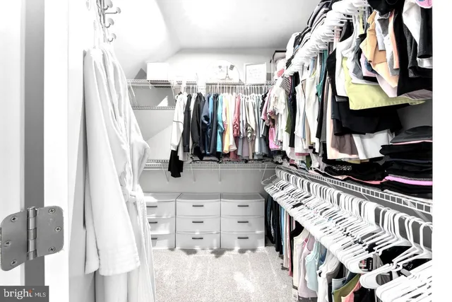 a bedroom with a flat screen tv and a window