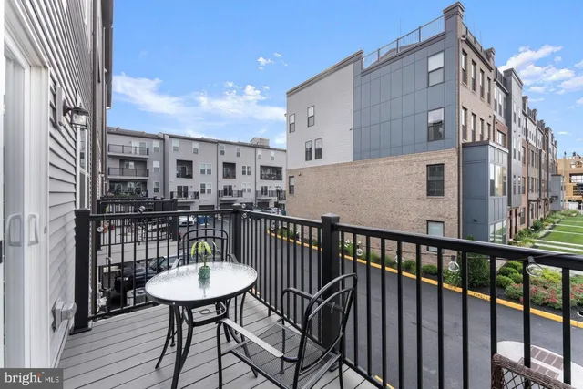 a view of a balcony with a table and chairs