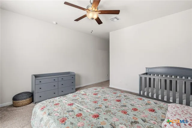 a bedroom with a bed and a chair