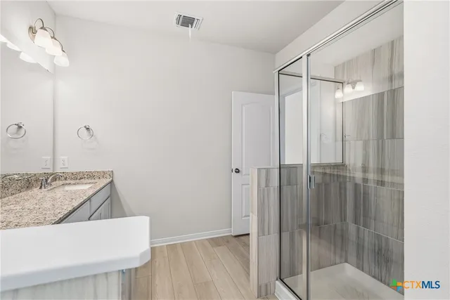 a spacious bedroom with a bed and a window