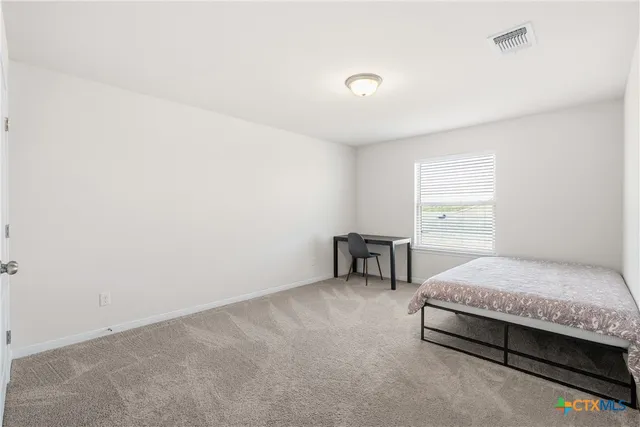 a view of a house with a large window and yard