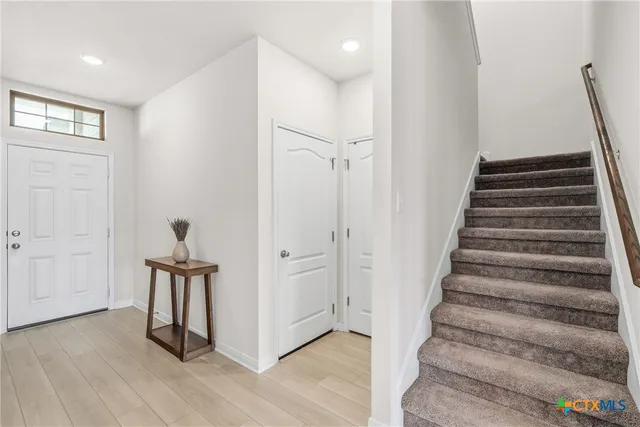 a view of entryway with stairs and wooden floor