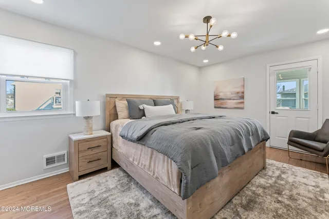 a spacious bedroom with a bed a couch and dresser