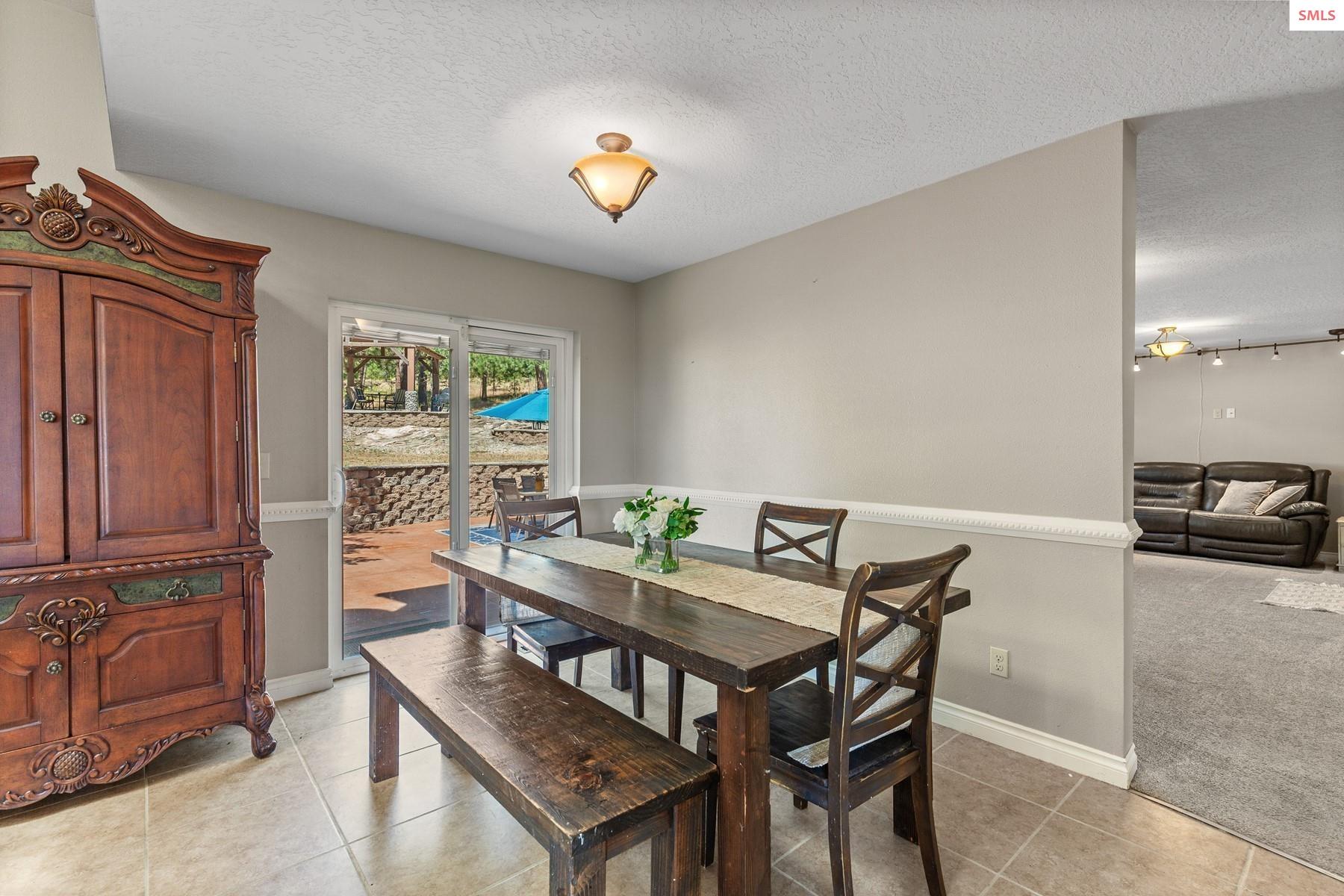 18341 West Highway 53 Rathdrum, ID 83858 - Photo 9 of 41 From the dining room there is slider access to the back patio.