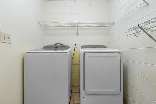 an empty room with a window and ceiling fan
