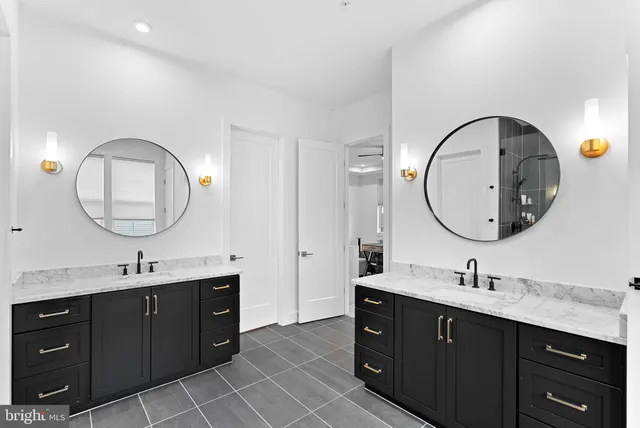 a bathroom with a double vanity sink and a mirror