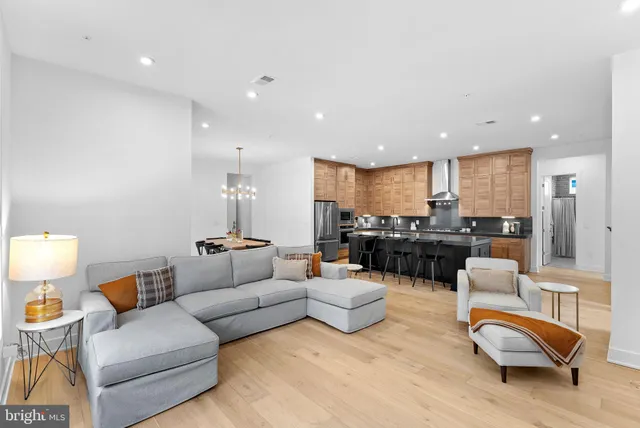 a living room with furniture and kitchen view