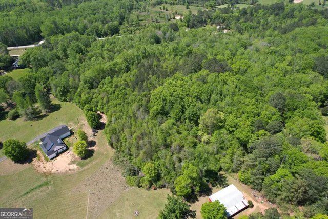 an aerial view of a house with a yard