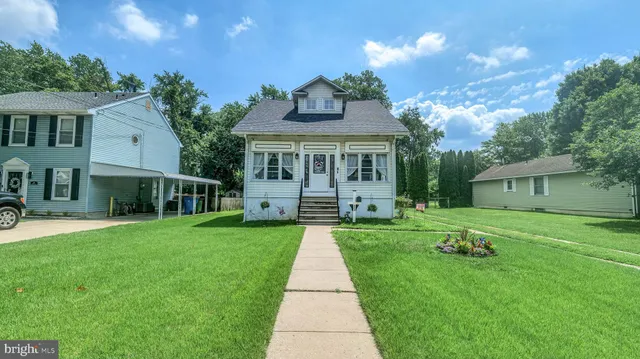 a front view of house with yard and green space