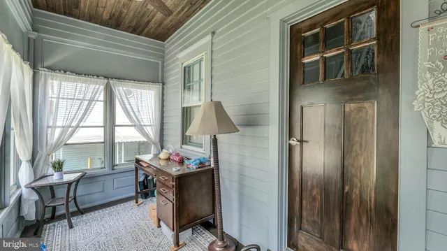 a dining room with furniture and a window