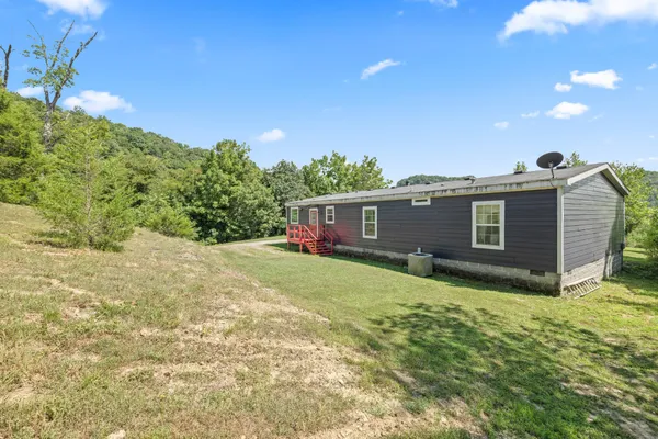 a view of a house with backyard porch and sitting area