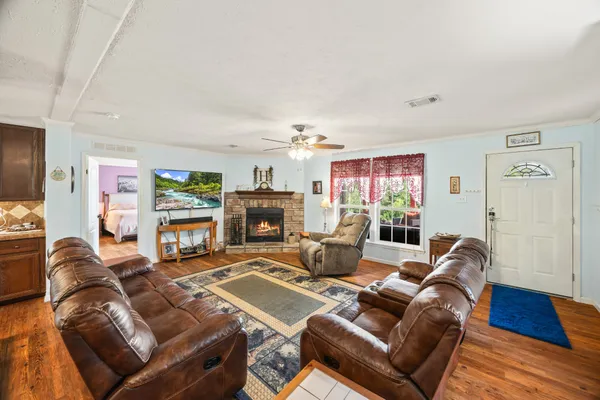 a living room with furniture a fireplace and a flat screen tv