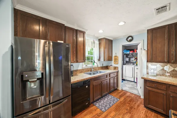 a kitchen with stainless steel appliances granite countertop a refrigerator stove microwave and sink