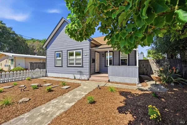 a view of a house with backyard and sitting area