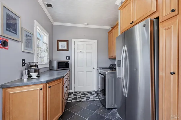 a kitchen with stainless steel appliances a refrigerator and a sink