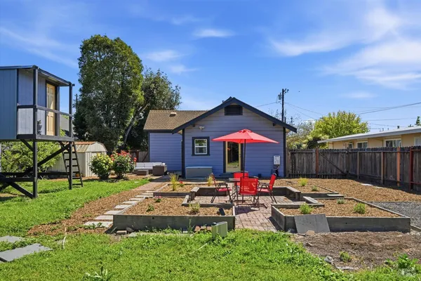 a front view of house with yard and outdoor seating