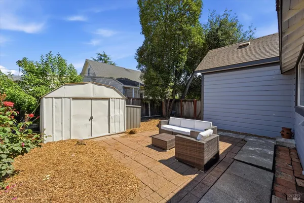 a view of a backyard with sitting area