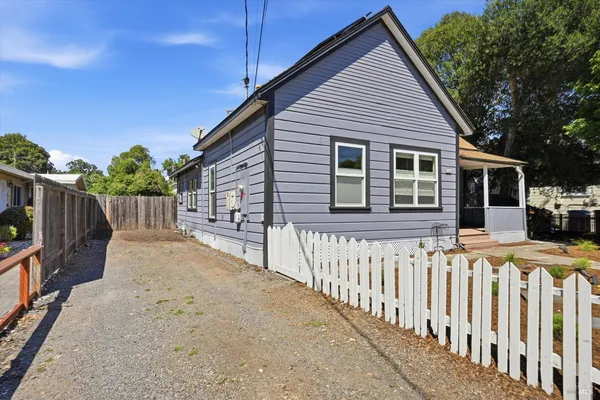 a front view of a house with wooden fence