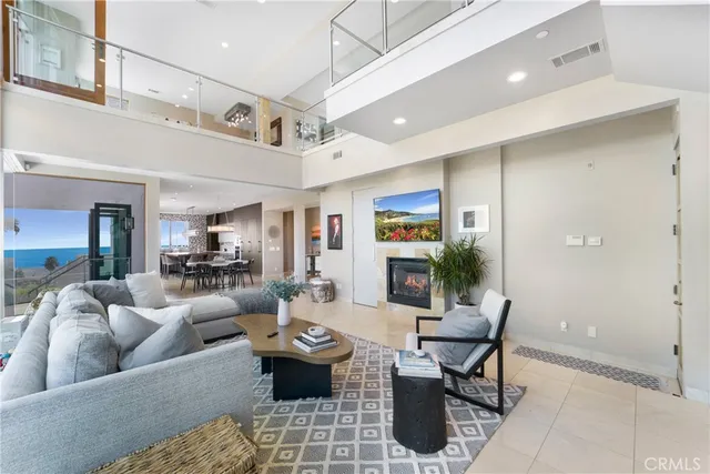 a living room with furniture kitchen view and a table