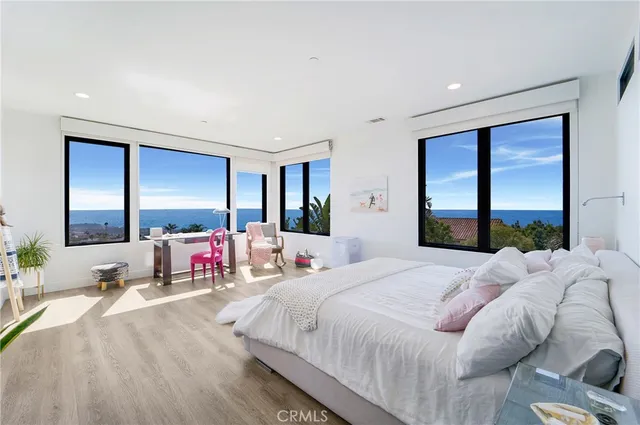 a large bedroom with a large bed and a large window