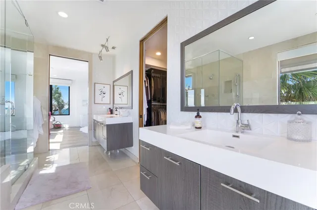 a spacious bathroom with a sink a large mirror and a bathtub