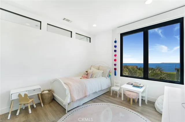 a bedroom with a bed and large window