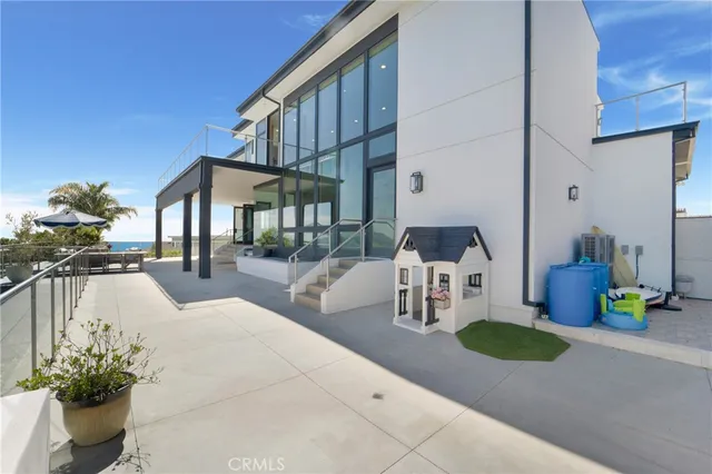 a view of a patio with couches table and chairs and potted plants