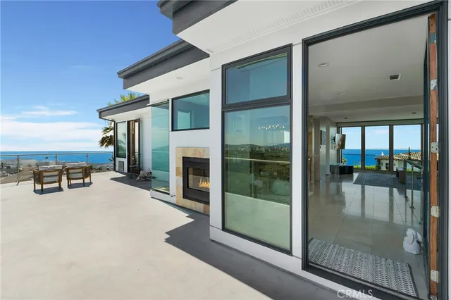 a view of a livingroom with furniture and floor to ceiling window