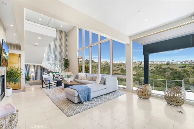 a living room with furniture and a floor to ceiling window