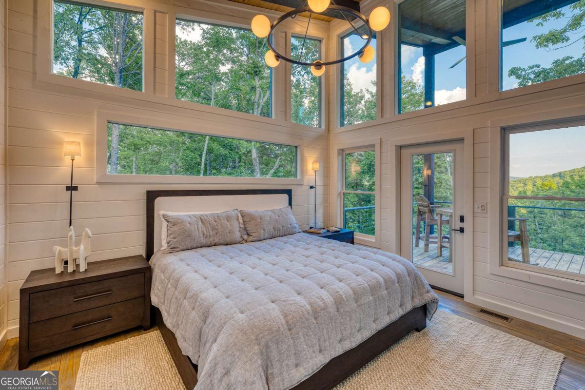 281 Raintree Bend Blue Ridge, GA 30513 - Photo 12 of 56 a bed sitting in a bedroom next to a window