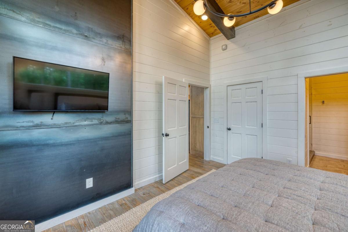 281 Raintree Bend Blue Ridge, GA 30513 - Photo 14 of 56 a bedroom with a bed and a flat screen tv