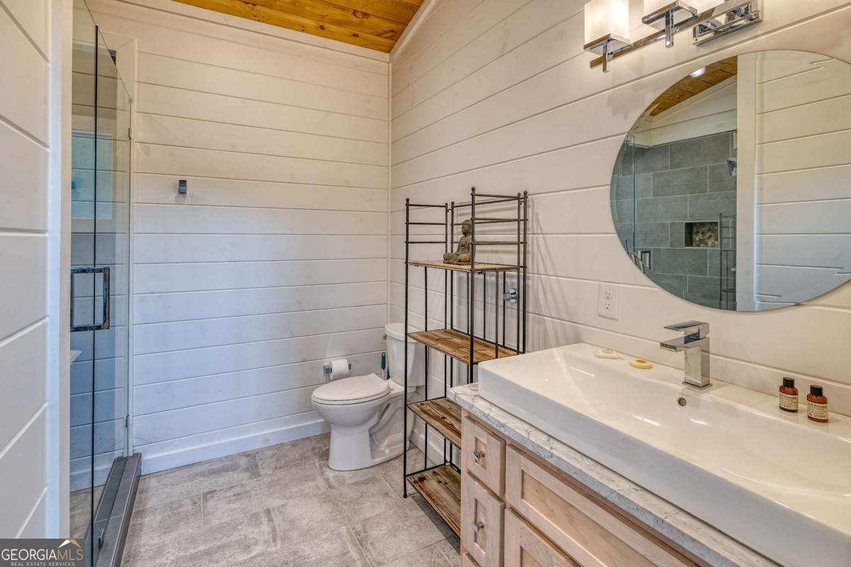 281 Raintree Bend Blue Ridge, GA 30513 - Photo 16 of 56 a bathroom with a sink a toilet and shower