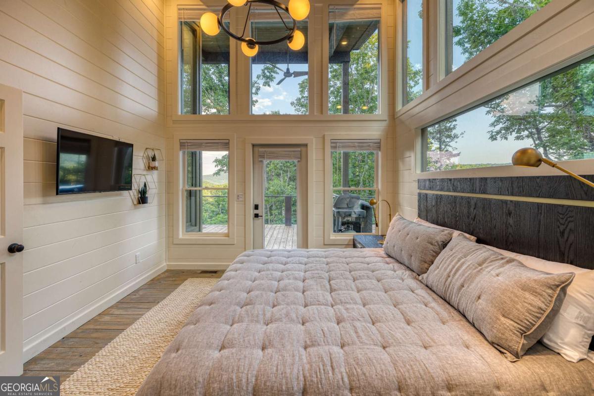 281 Raintree Bend Blue Ridge, GA 30513 - Photo 24 of 56 a bedroom with a bed and a large window