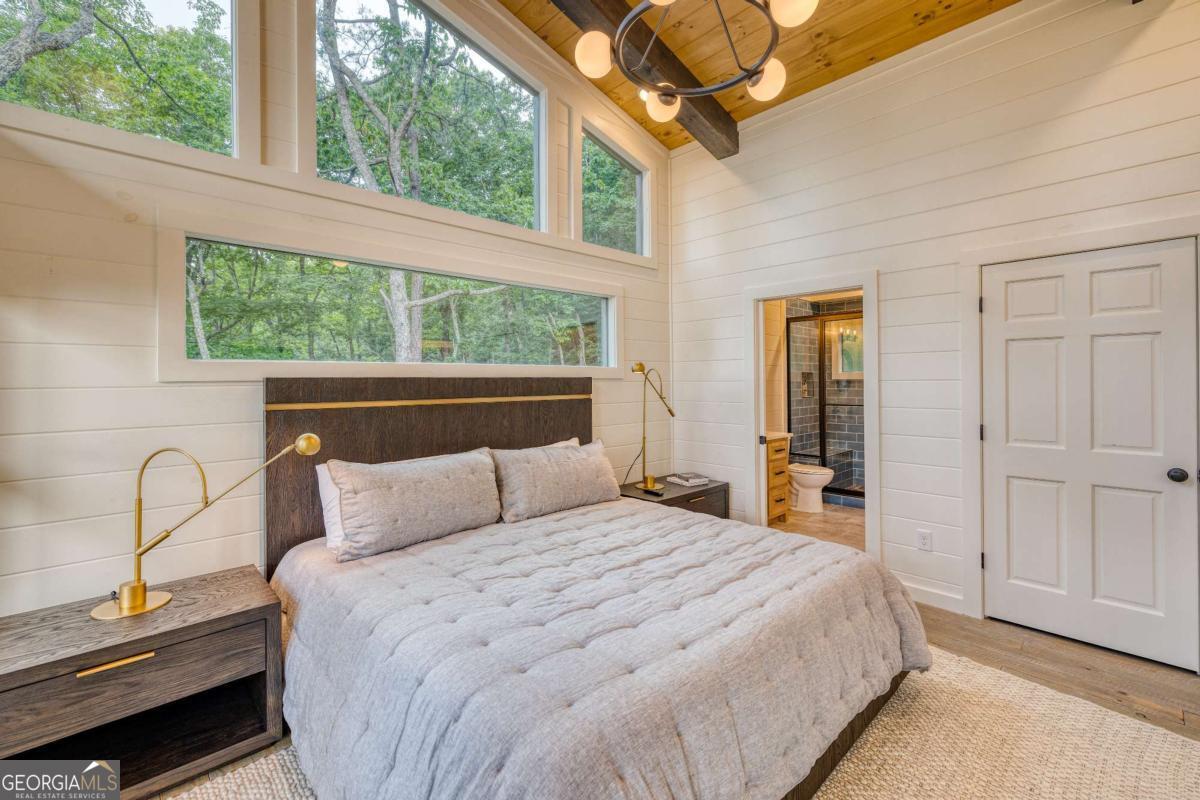 281 Raintree Bend Blue Ridge, GA 30513 - Photo 25 of 56 a bedroom with a bed and a window