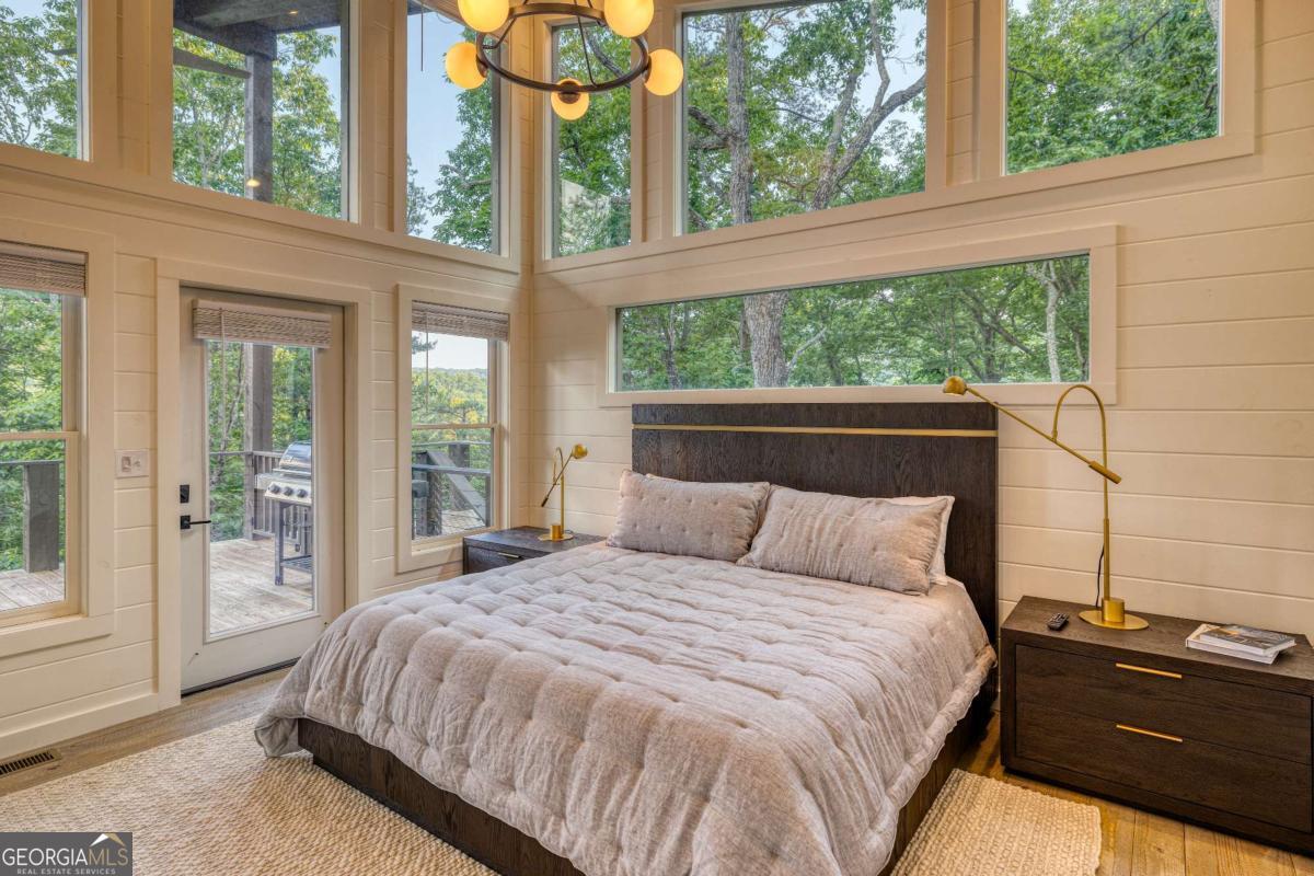 281 Raintree Bend Blue Ridge, GA 30513 - Photo 26 of 56 a bedroom with a bed and a large window