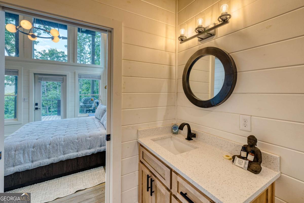281 Raintree Bend Blue Ridge, GA 30513 - Photo 28 of 56 a bathroom with a sink and a mirror