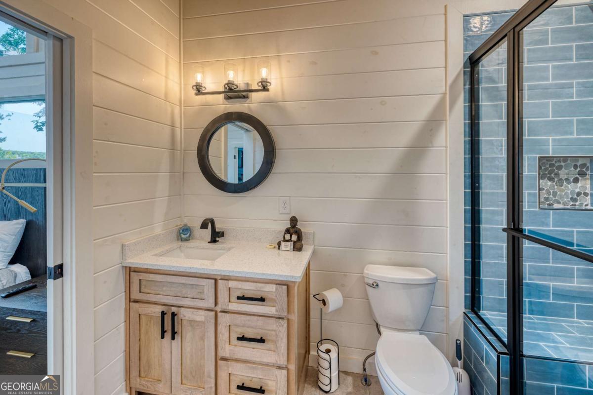 281 Raintree Bend Blue Ridge, GA 30513 - Photo 29 of 56 a bathroom with a toilet sink and mirror