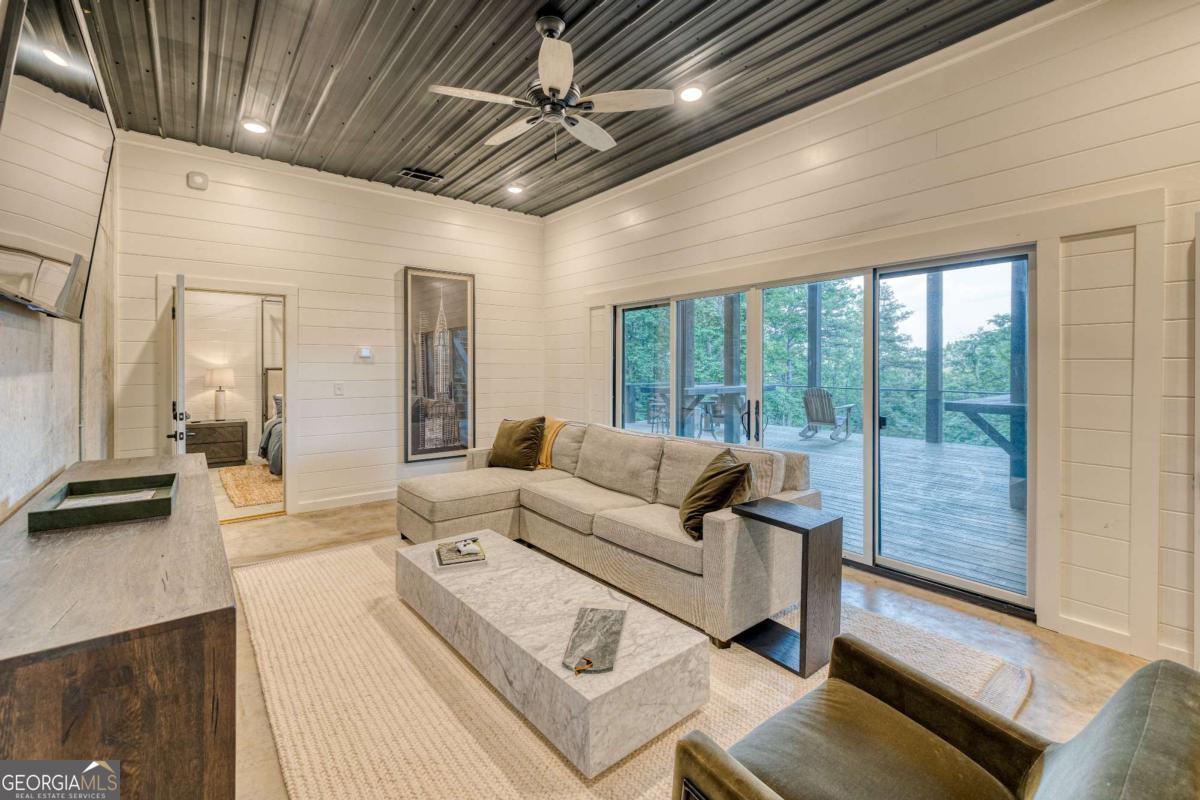 281 Raintree Bend Blue Ridge, GA 30513 - Photo 36 of 56 a living room with furniture and a large window