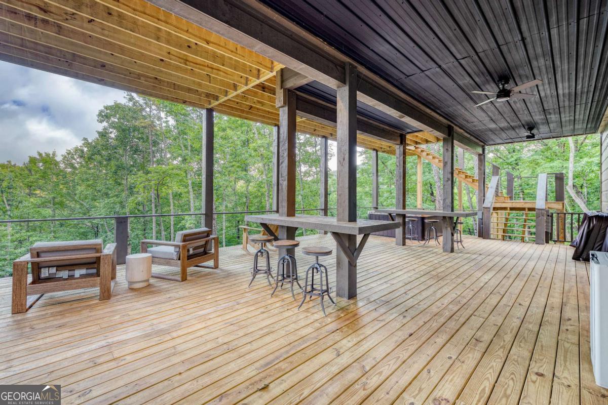 281 Raintree Bend Blue Ridge, GA 30513 - Photo 39 of 56 a view of a patio with wooden floor table and chairs