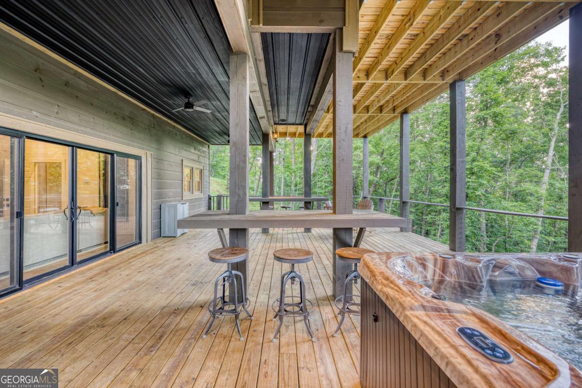 281 Raintree Bend Blue Ridge, GA 30513 - Photo 41 of 56 a view of a patio with a table chairs and wooden floor