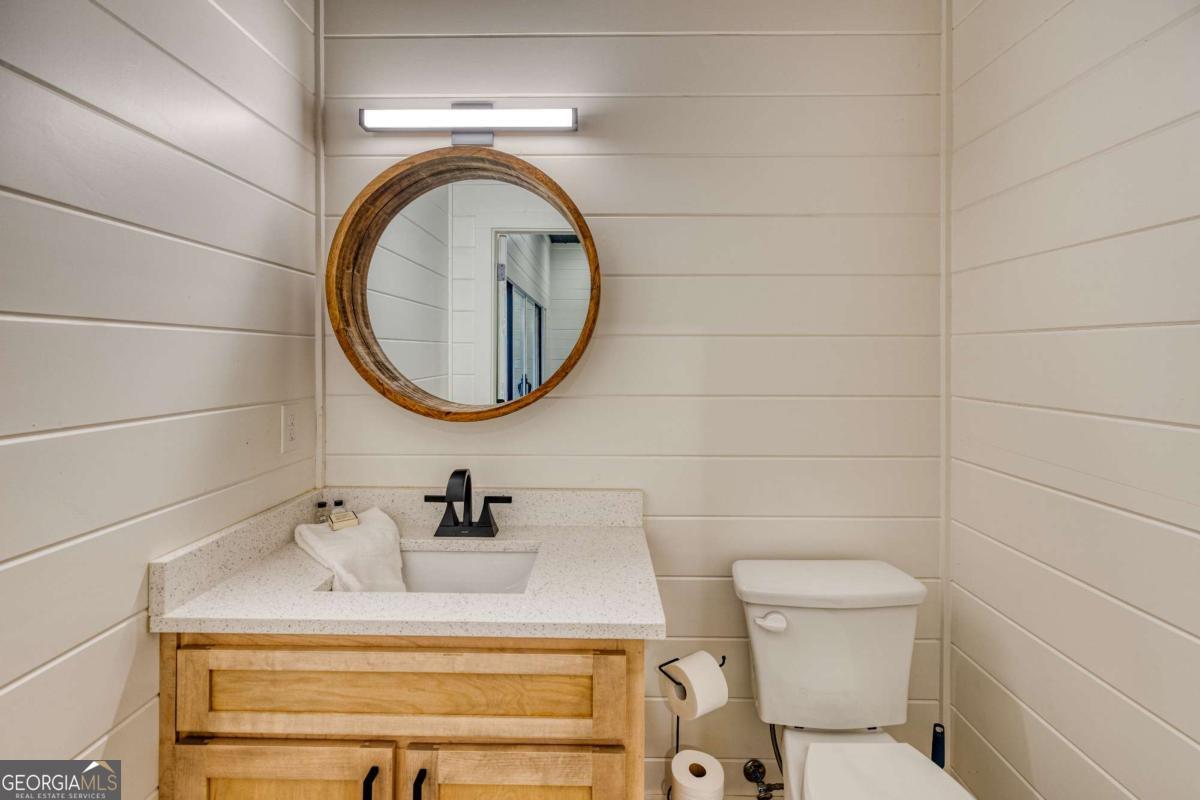 281 Raintree Bend Blue Ridge, GA 30513 - Photo 44 of 56 a bathroom with a sink mirror vanity and toilet
