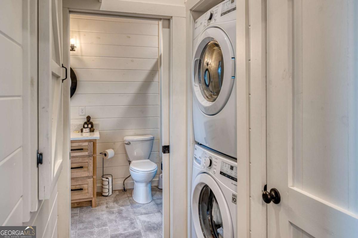 281 Raintree Bend Blue Ridge, GA 30513 - Photo 45 of 56 a view of a storage and utility room with dryer and washer