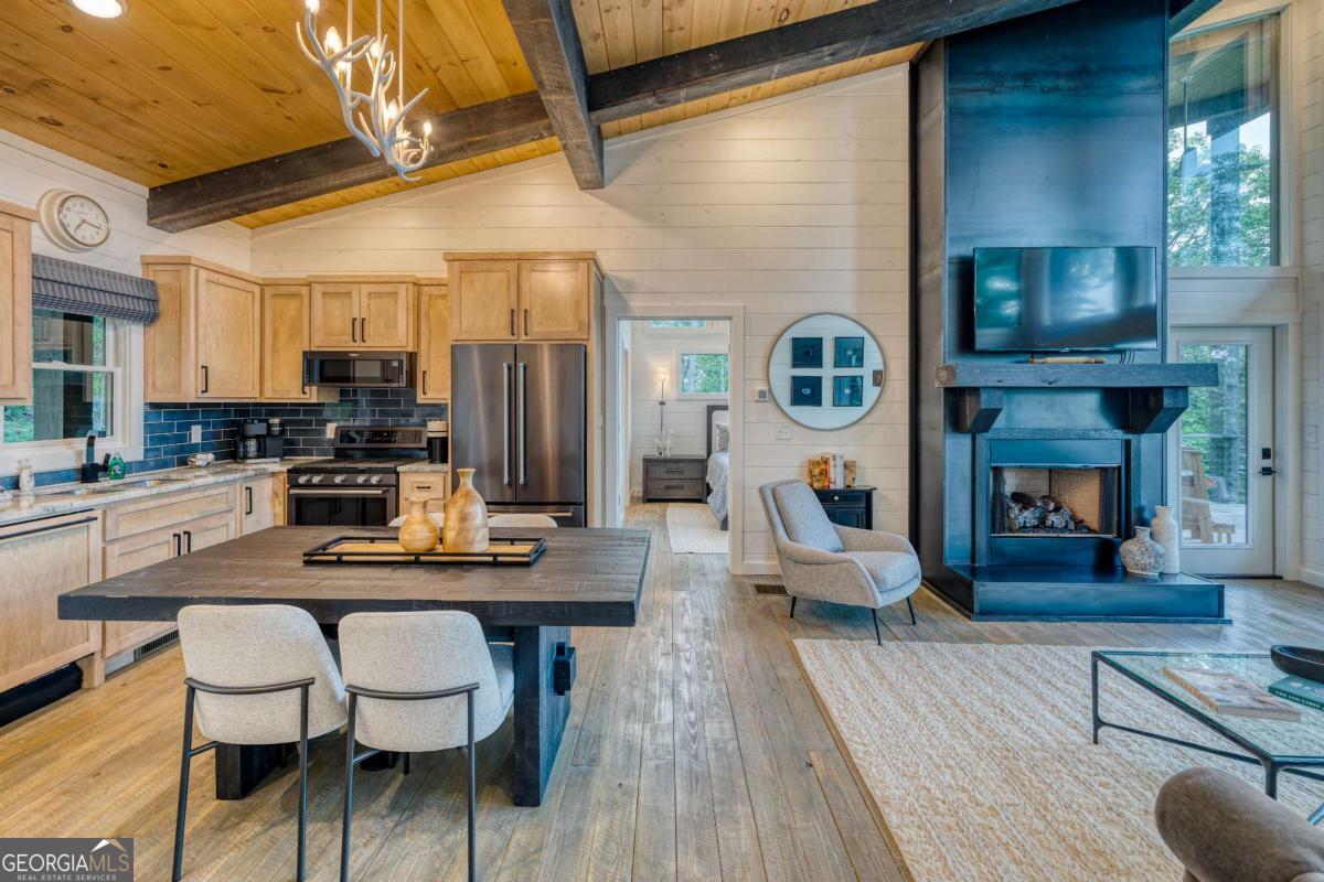 281 Raintree Bend Blue Ridge, GA 30513 - Photo 5 of 56 a dining hall with stainless steel appliances kitchen island granite countertop furniture and a fireplace