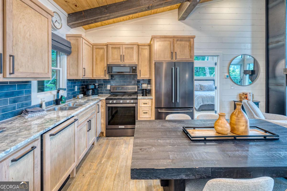 281 Raintree Bend Blue Ridge, GA 30513 - Photo 6 of 56 a kitchen with stainless steel appliances granite countertop a stove a sink and a refrigerator