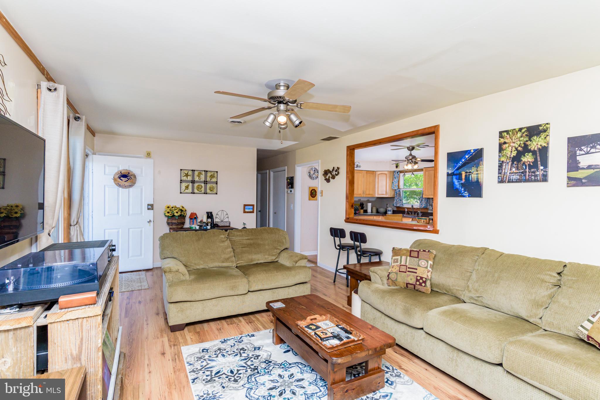 23212 Haines Point Road Chance, MD 21821 - Photo 26 of 57 a living room with furniture and a flat screen tv